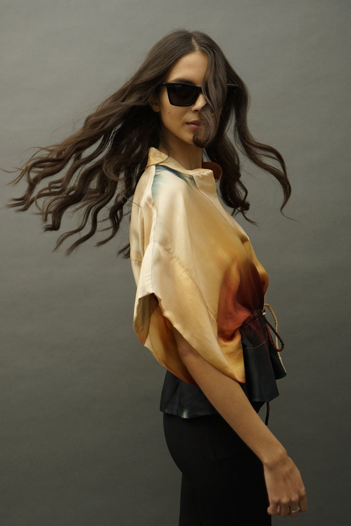 Side profile showing relaxed drape and muted tie-dye pattern on silk top