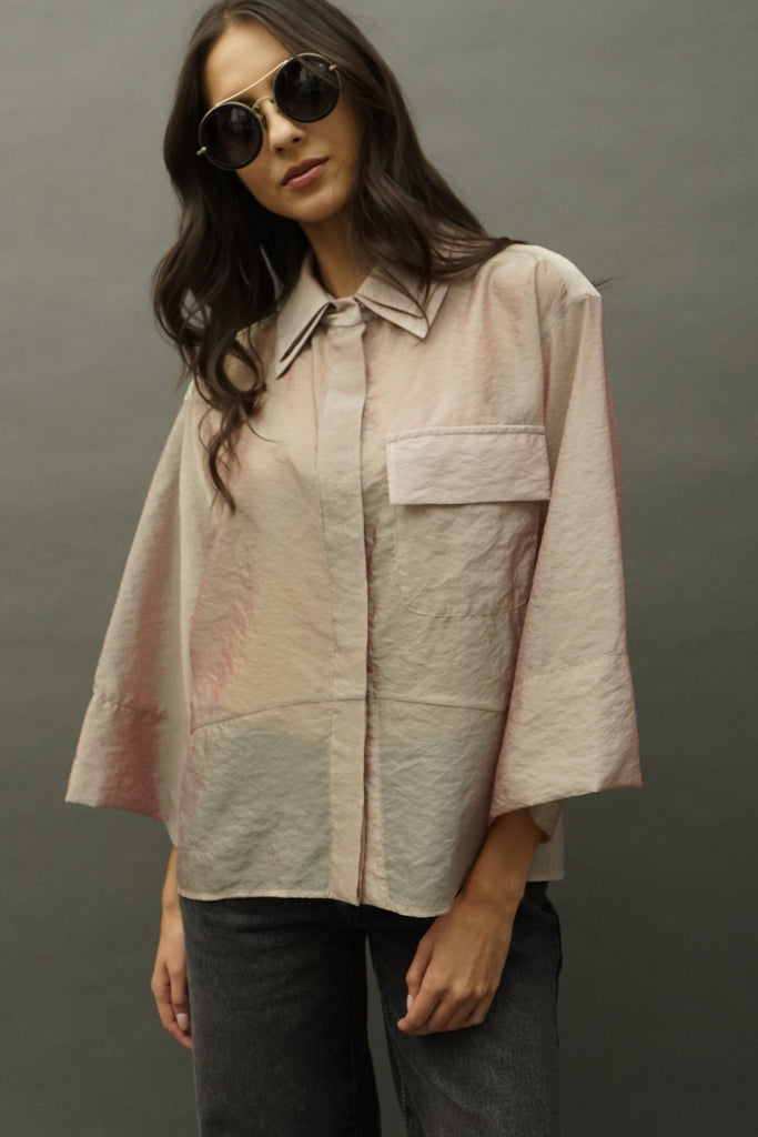 Front view of Adi opal silk organza blouse with iridescent drape, double collar, large pocket and oversized sleeves