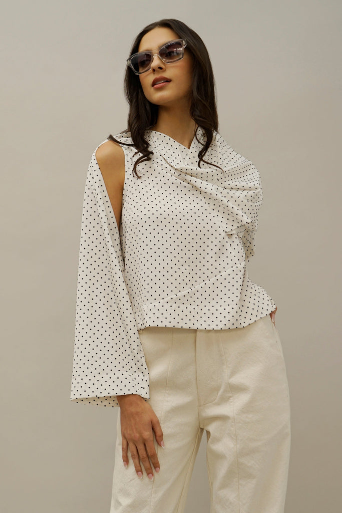 Asymmetrical Polka Dot Blouse – Modern Women's Fashion Top | Chic off-shoulder polka dot blouse with draped neckline and wide sleeve, perfect for effortless elegance.