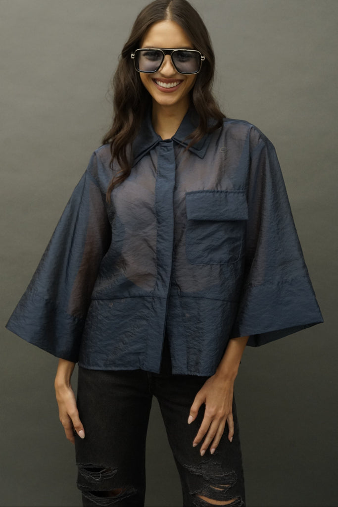 Front view of Adi navy silk organza blouse with airy drape, studio lighting