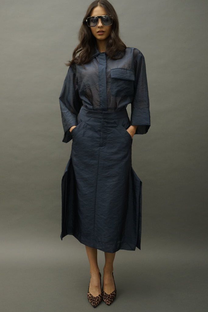 Front view of women wearing Effie navy silk organza skirt paired with a matching oversized blouse tucked in.