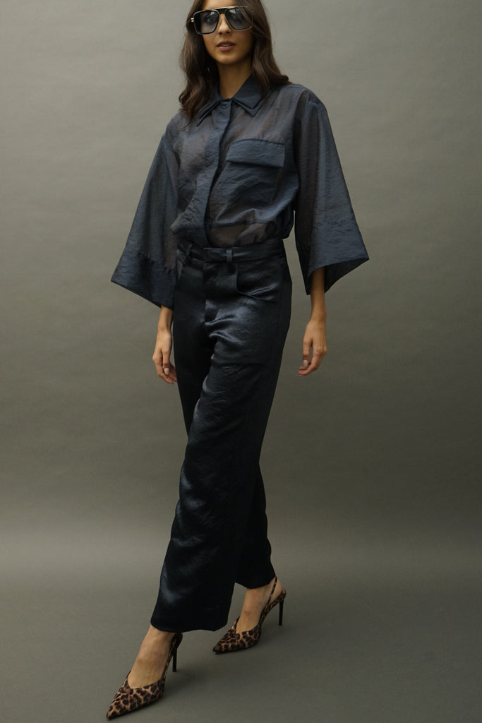 Side profile showing fluid drape of wide-leg silhouette
