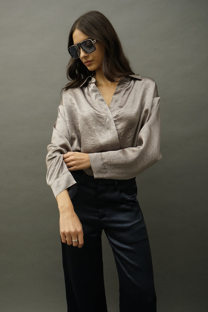 Front view of Idle khaki satin wrap blouse with snapped elastic waist, and long elegant sleeves