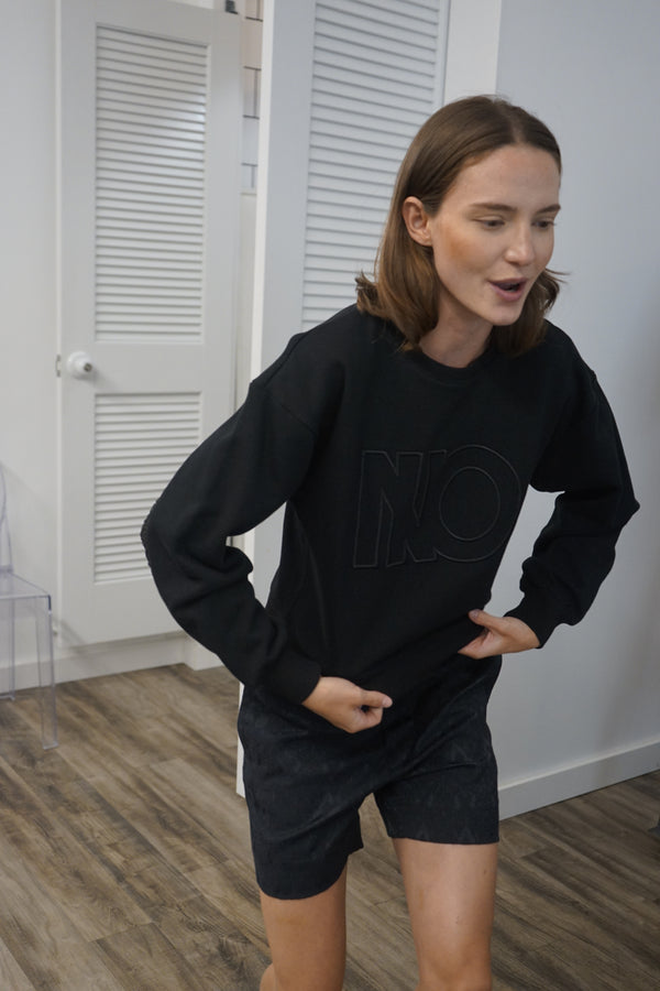 A video thumbnail showing the NINO sweatshirt in motion to demonstrate the flow and texture of the sheer crinkle detail.