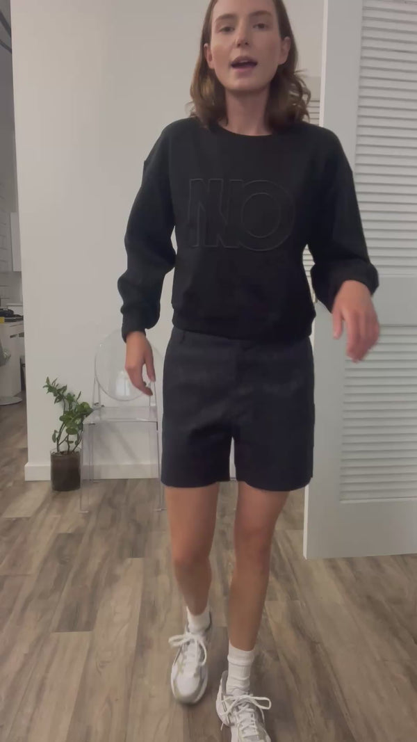 A video thumbnail showing a model moving or walking in the shorts to demonstrate their fit and how they move.